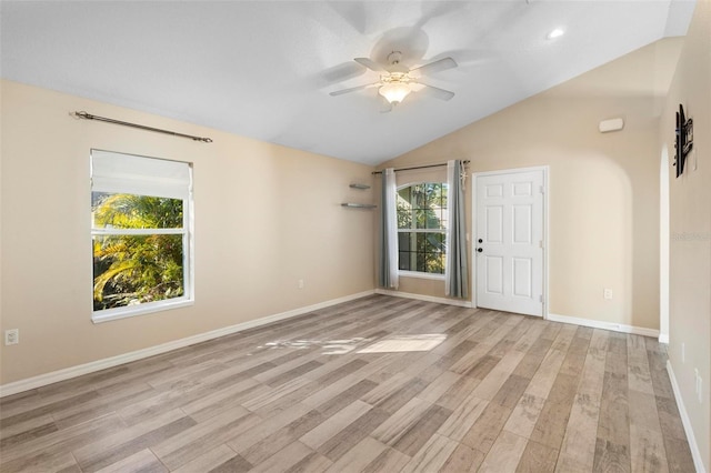 unfurnished room featuring baseboards, vaulted ceiling, light wood finished floors, and ceiling fan