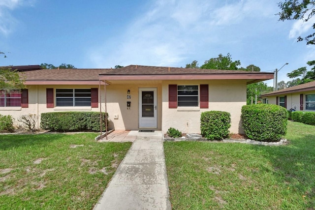 ranch-style house featuring a front lawn