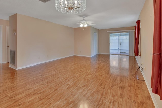 unfurnished room with light hardwood / wood-style flooring and ceiling fan with notable chandelier