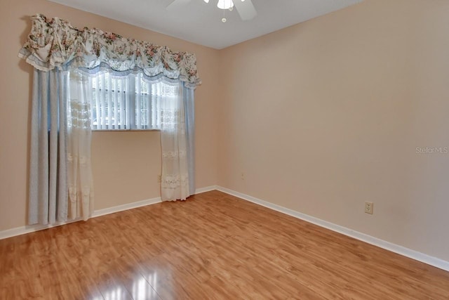 empty room with ceiling fan and wood-type flooring