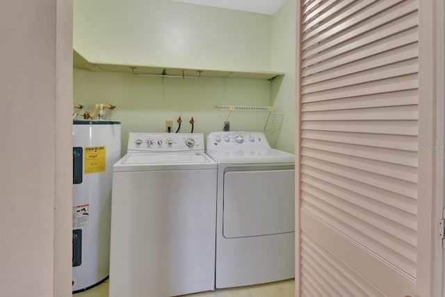 clothes washing area featuring washing machine and dryer and electric water heater