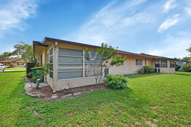 rear view of house with a yard