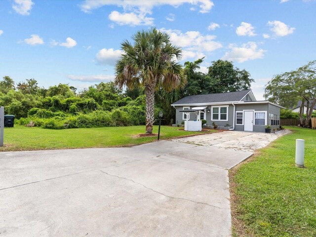 ranch-style home with a front lawn