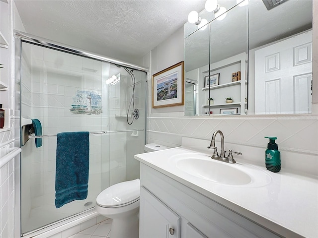 bathroom featuring vanity, a shower with shower door, tile walls, toilet, and decorative backsplash