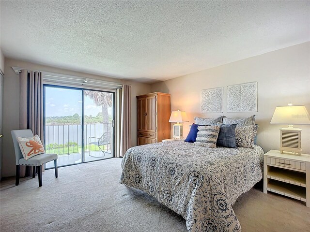 bedroom with light colored carpet, access to outside, and a textured ceiling