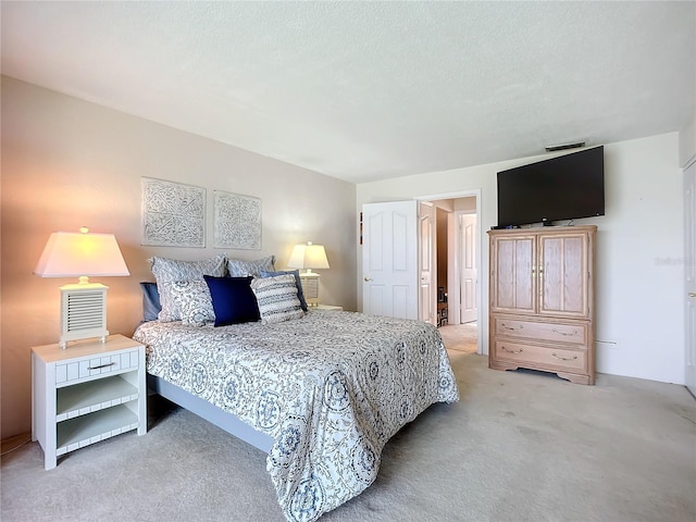 carpeted bedroom with a textured ceiling