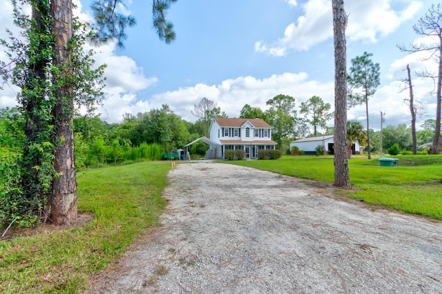 view of front of property with a front yard and a carport