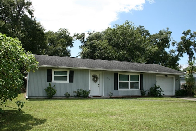 ranch-style house featuring a garage and a front lawn