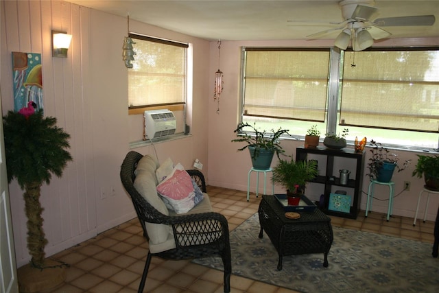 interior space with ceiling fan and cooling unit