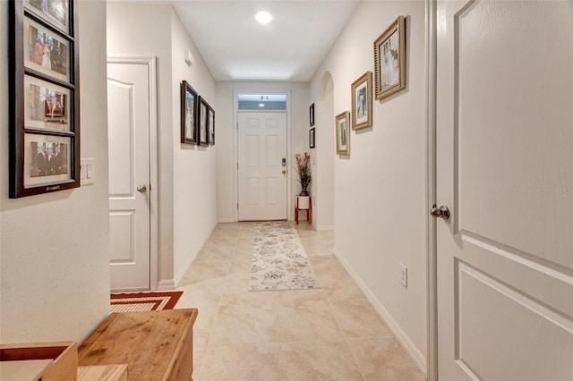 entryway with light tile patterned floors and baseboards