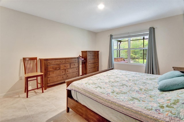 bedroom featuring baseboards and light tile patterned floors