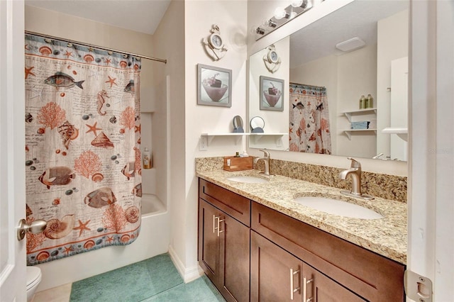 bathroom featuring toilet, double vanity, shower / bath combo, and a sink