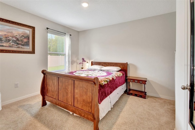 bedroom with carpet floors and baseboards