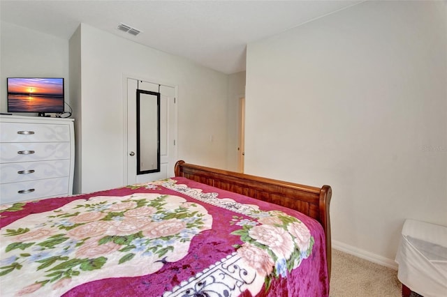 carpeted bedroom with visible vents and baseboards