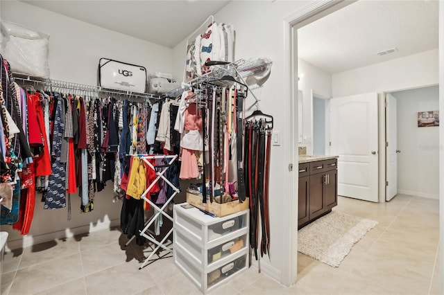 spacious closet featuring visible vents and light tile patterned flooring