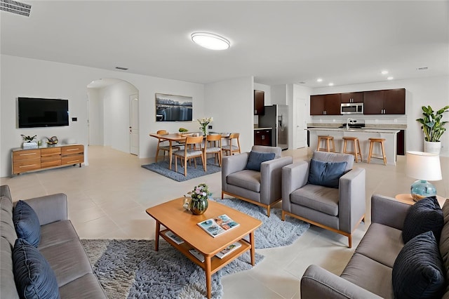 317 Nowell Loop, Deland, FL 32724 - living area with arched walkways, light tile patterned floors, and recessed lighting