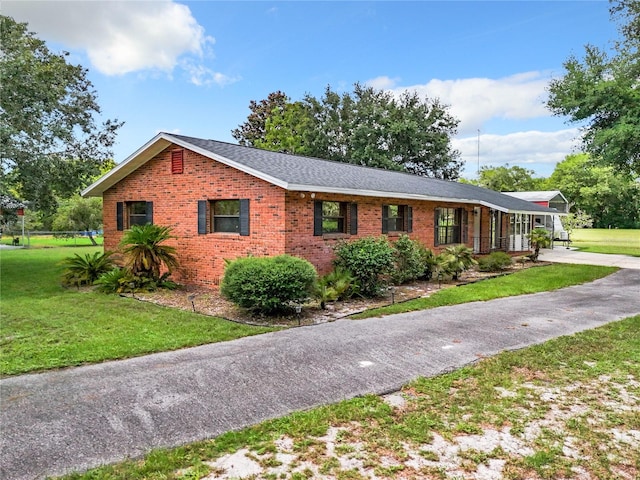 ranch-style home with a front lawn