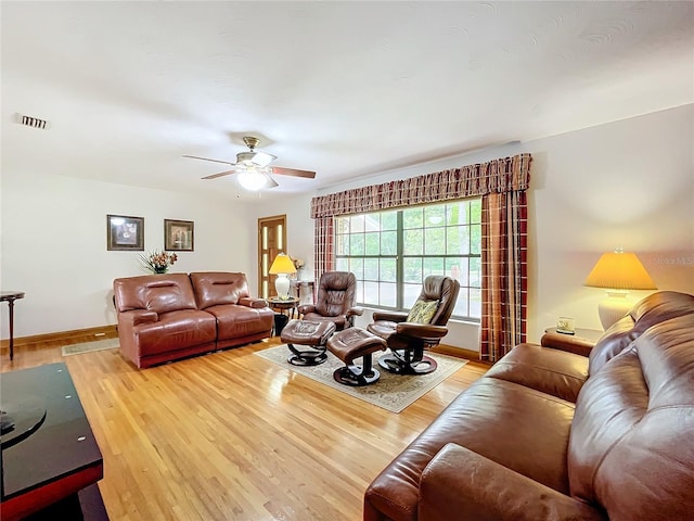 living room featuring ceiling fan and light hardwood / wood-style floors