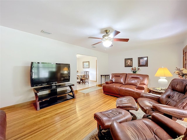 living room with ceiling fan and light wood-type flooring