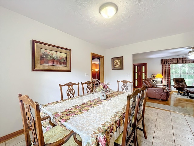 tiled dining area with ceiling fan