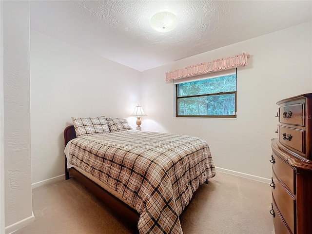 carpeted bedroom featuring a textured ceiling