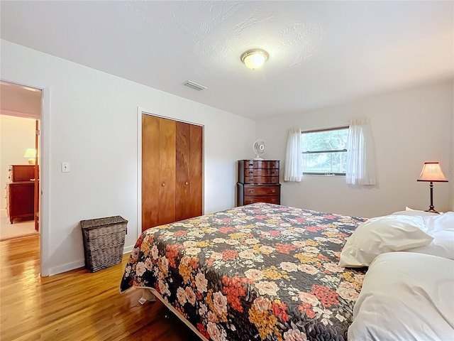 bedroom with a closet and wood-type flooring