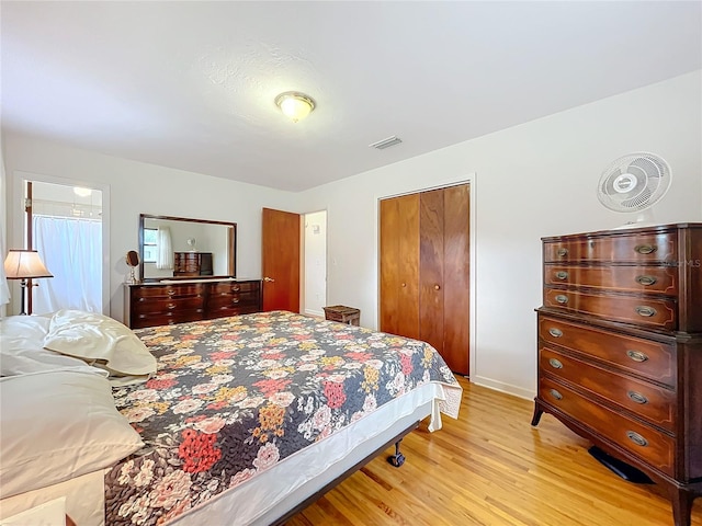 bedroom with light wood-type flooring and a closet