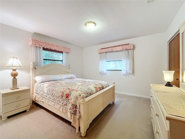 bedroom with carpet and multiple windows