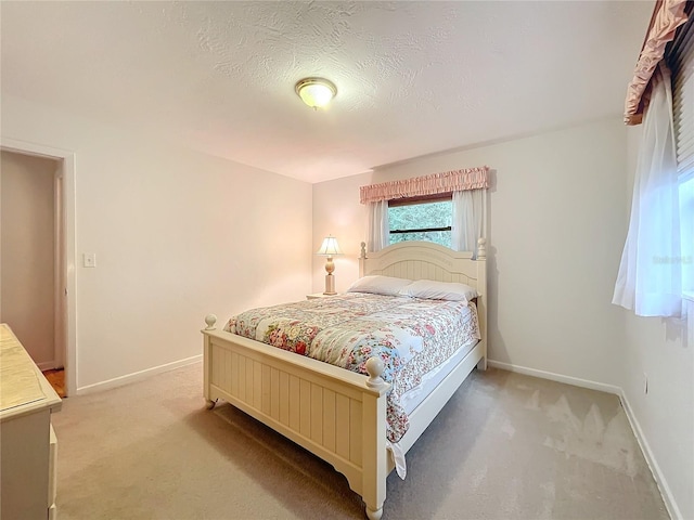 bedroom with a textured ceiling and carpet