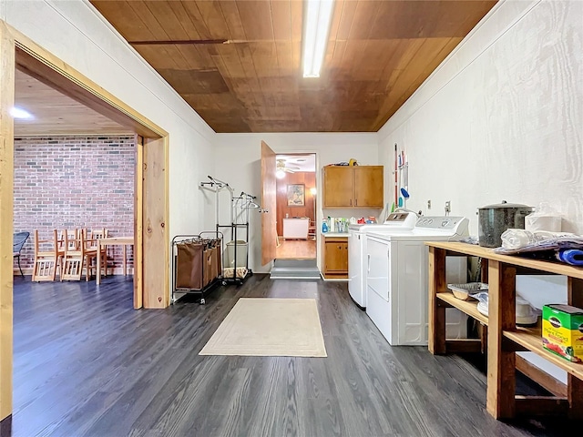 washroom with brick wall, cabinets, washer and dryer, dark hardwood / wood-style flooring, and wood ceiling