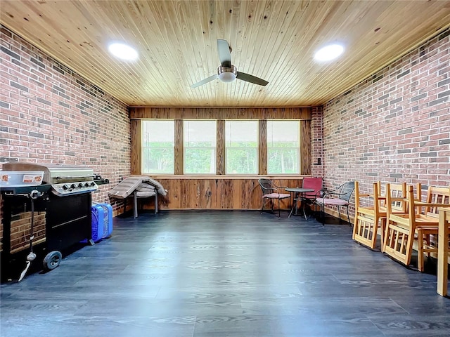 interior space with brick wall, plenty of natural light, and ceiling fan