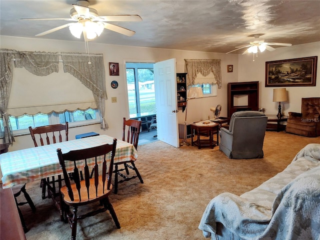 carpeted living room with ceiling fan and plenty of natural light