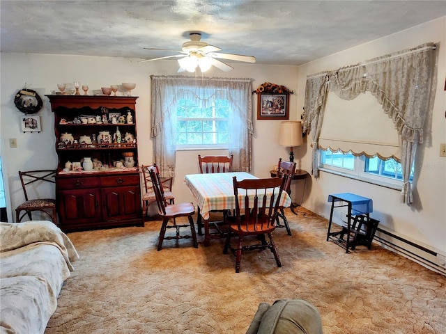 dining space featuring light carpet, ceiling fan, and a textured ceiling