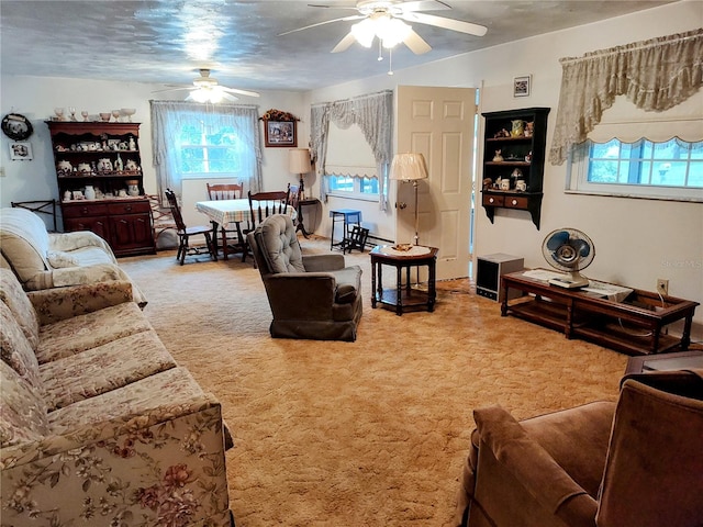 carpeted living room with ceiling fan