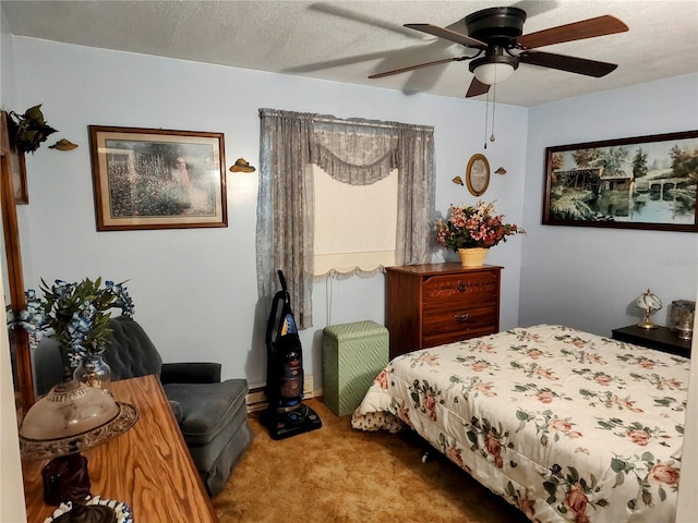 carpeted bedroom with ceiling fan and a textured ceiling