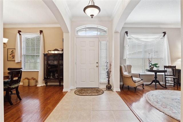 foyer featuring crown molding and light wood-type flooring