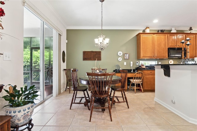 dining space featuring ornamental molding, light tile patterned flooring, and an inviting chandelier