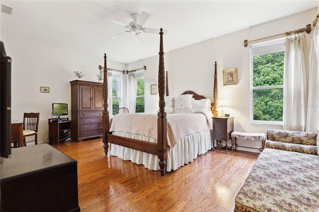 bedroom with multiple windows, ceiling fan, and light hardwood / wood-style flooring