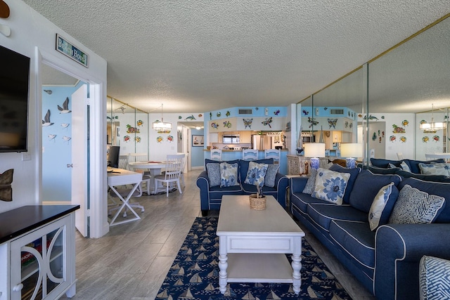 living room with a textured ceiling and hardwood / wood-style floors