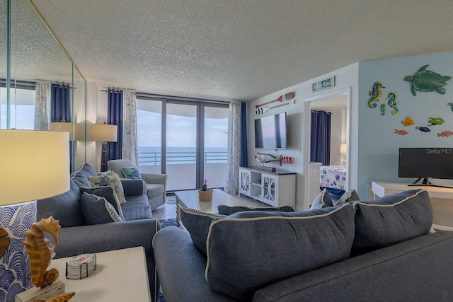 living room featuring a textured ceiling and floor to ceiling windows