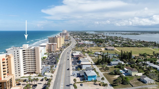 bird's eye view featuring a water view and a beach view