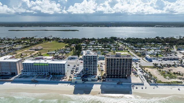 birds eye view of property featuring a view of the beach and a water view