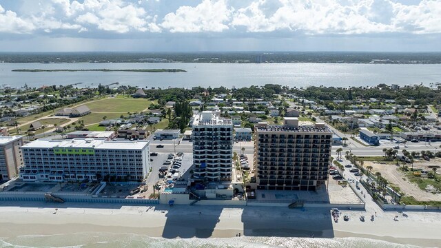 bird's eye view featuring a view of the beach and a water view