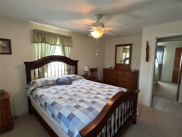 carpeted bedroom with a textured ceiling and ceiling fan