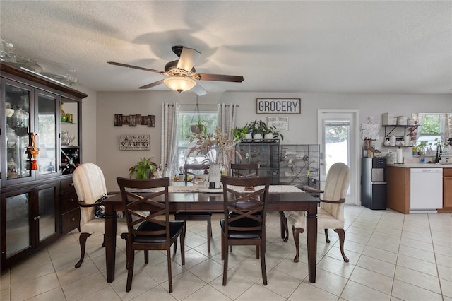 tiled dining area featuring ceiling fan and a textured ceiling