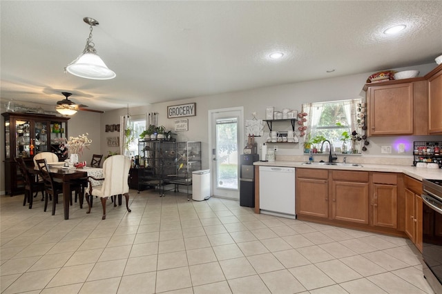 kitchen featuring white dishwasher, decorative light fixtures, sink, ceiling fan, and a textured ceiling