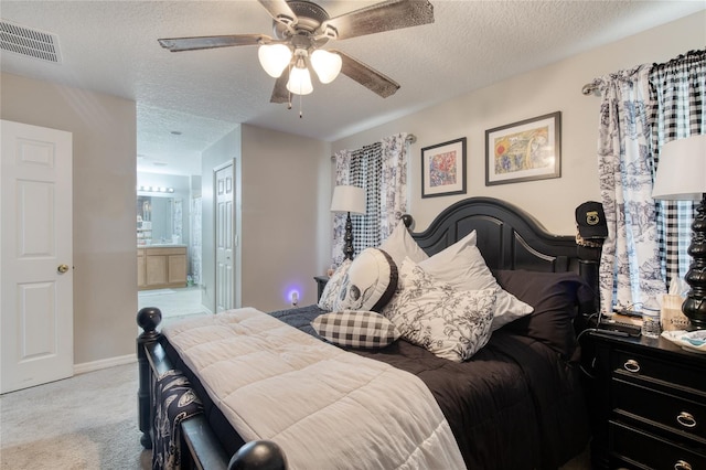 bedroom featuring carpet, ceiling fan, connected bathroom, and a textured ceiling