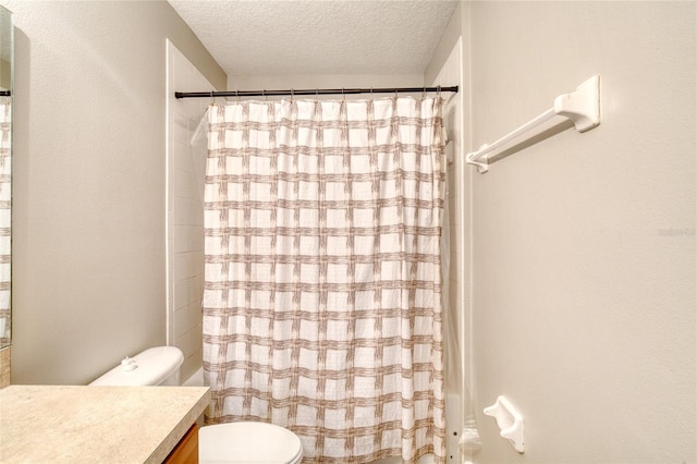 bathroom featuring a textured ceiling, vanity, toilet, and a shower with curtain