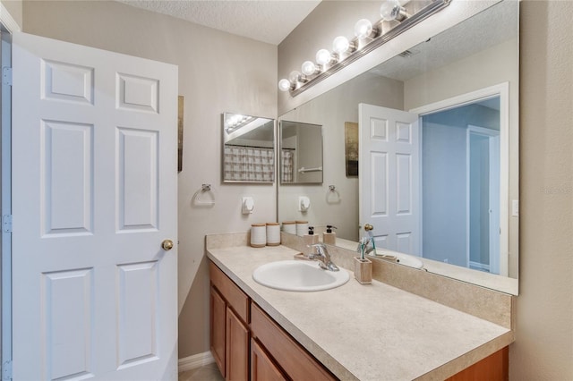 bathroom with a textured ceiling and vanity