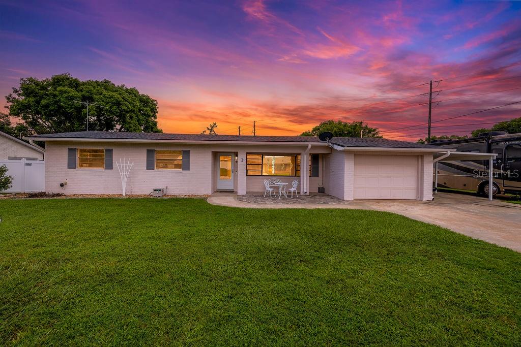 ranch-style house featuring a garage and a yard